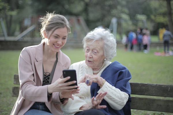 Care Worker sitting on park bench